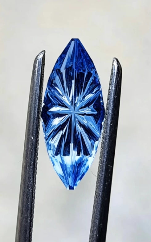 Matthew-1.5ct marquise-cut blue sapphire center stone, flanked by a pair of pear-cut white diamond side stones (0.6ct total), set in platinum